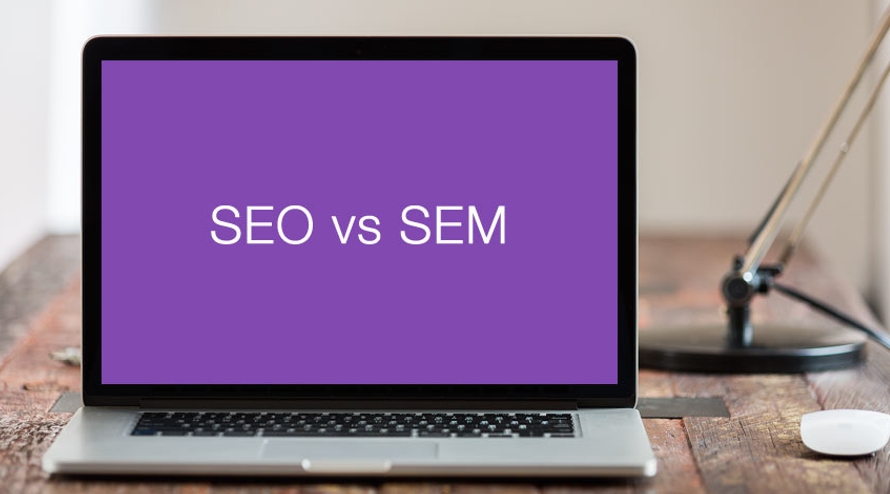 Laptop with the words SEO vs SEM on screen